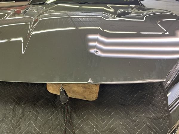 Dent in the Ferrari hood shown in the PDR light reflection