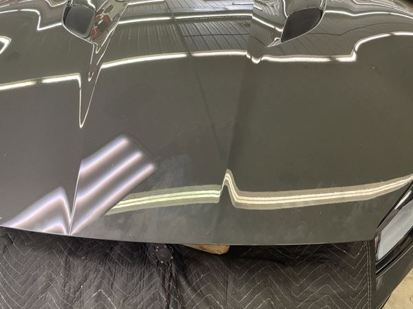 PDR light reflection across the dented Ferrari hood