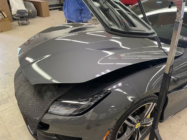 Ferrari Portofino with the hood raised for dent access