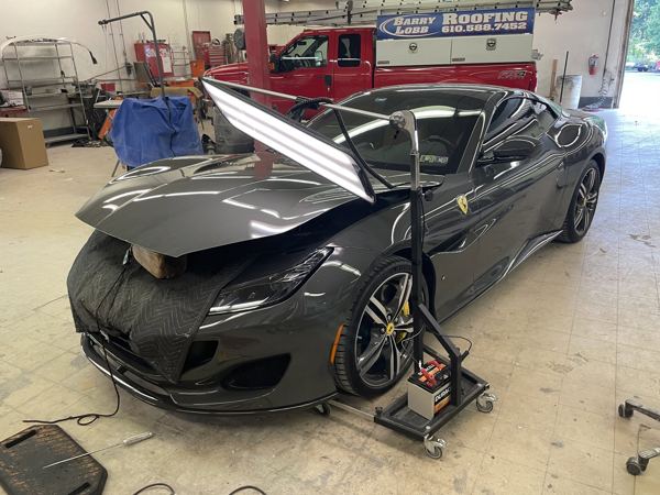 Ferrari Portofino in the shop with a PDR light on the hood