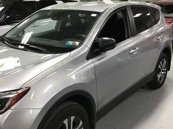 Silver Toyota RAV4 in for hail damage repair