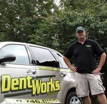 Ronny Albert standing beside a Dent Works by Ron vehicle